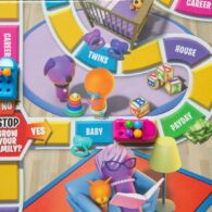 Close up of a board game spoofing the Life game, with stops along the way like "Stop! Grow your family?" and "Baby" "Payday" "House" "Twins" and "Career".