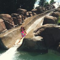 Kid splashing into pool after water slide ride at Sunriver Resort