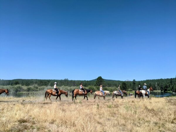 People on a guided trail ride through Sunriver’s pine forest